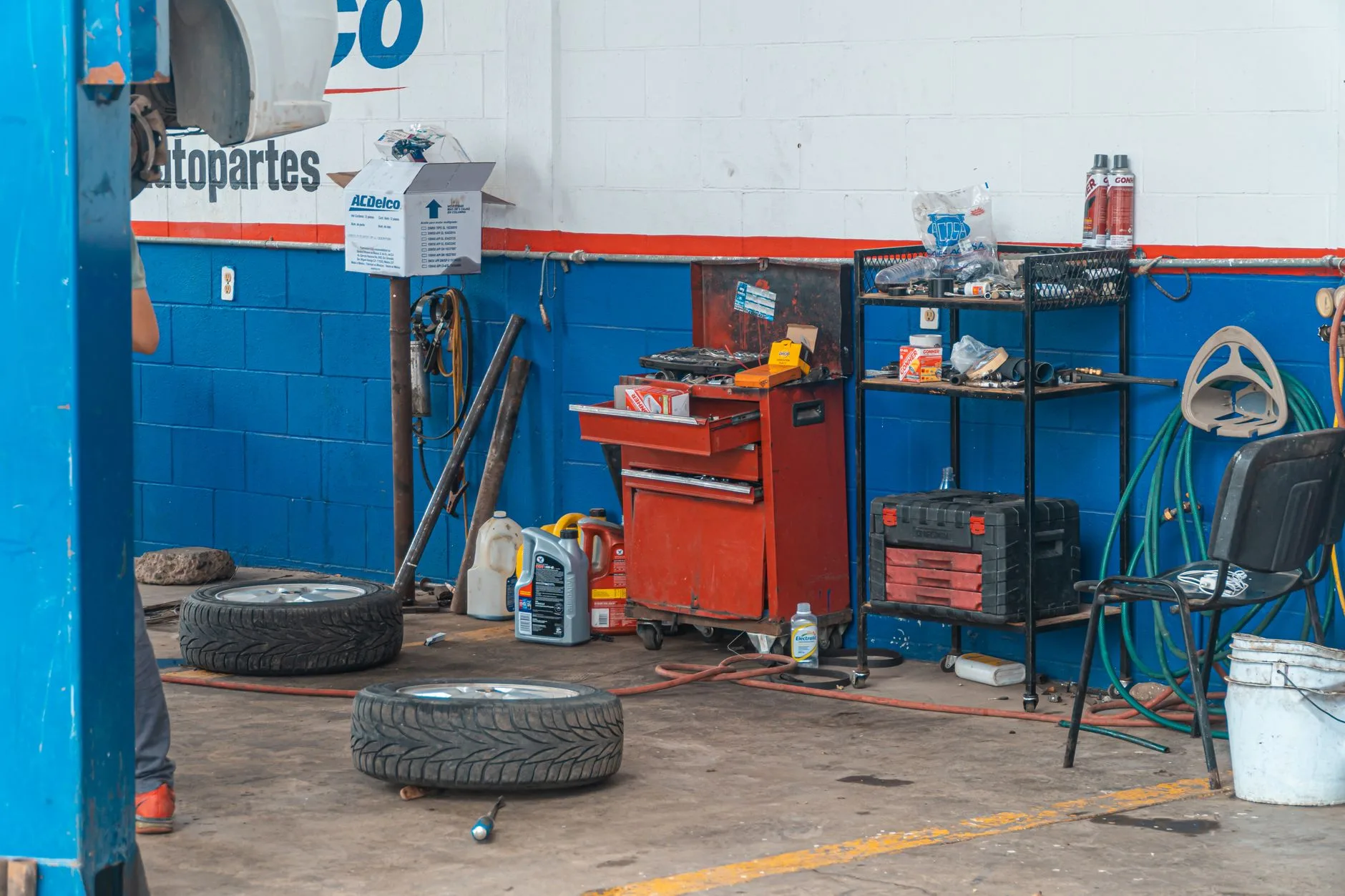 Context photo – workshop bay with tyres and tool trolley
